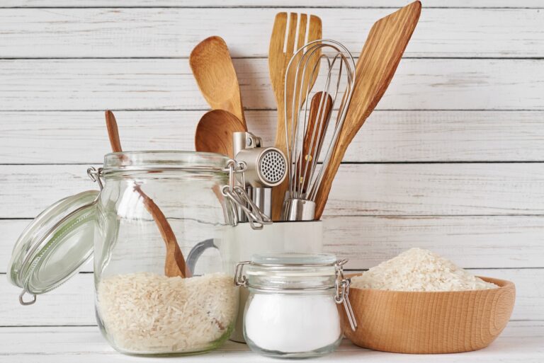 Kitchen tools and glass jar with rice
